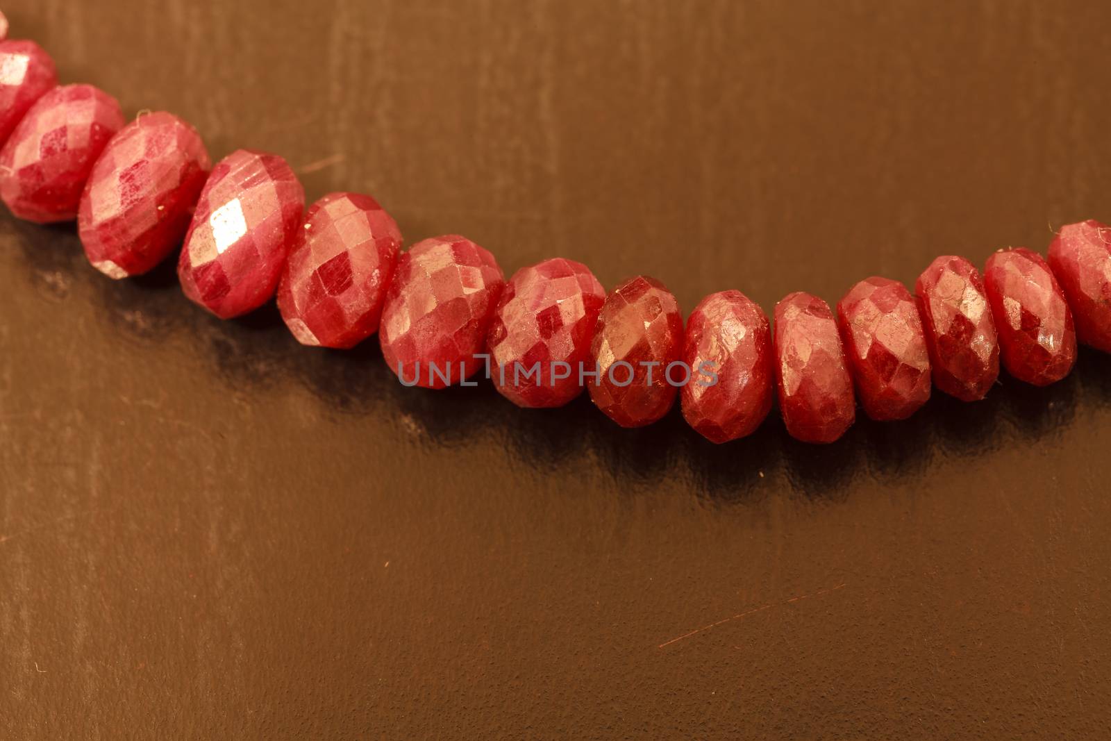 Necklace string of natural ruby bead jewelry on a black background