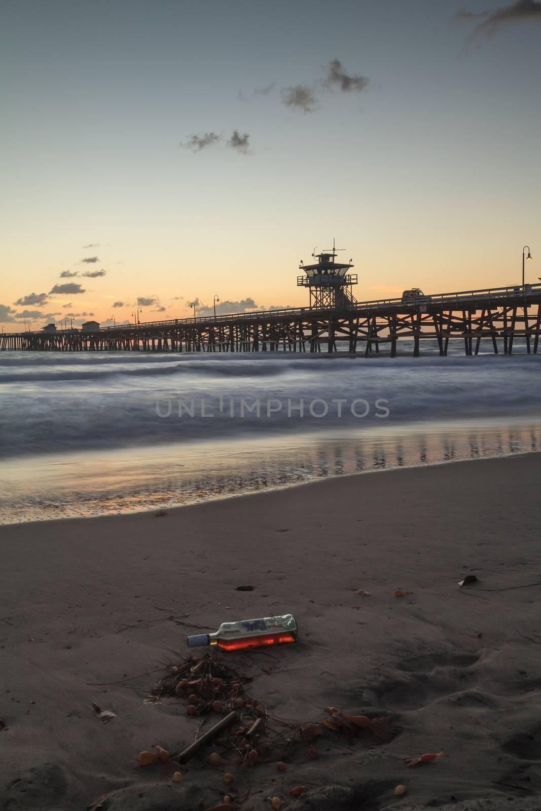 Bottle of alcohol on the beach by steffstarr