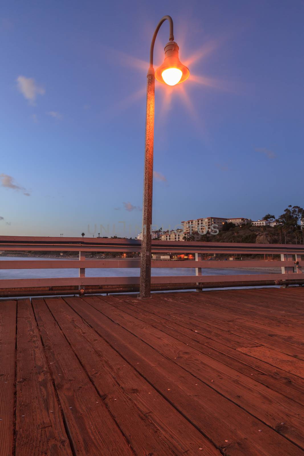 Lamp on the San Clemente pier at sunset in the fall in San Clemente, Southern California, United States