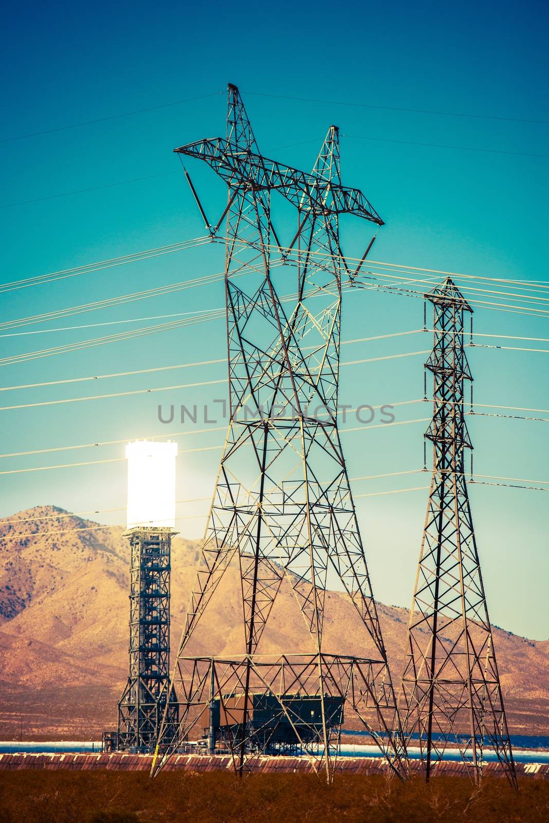Solar Thermal Power Plant and High Voltage Infrastructure. Energy Industry Theme.  Concentrated Solar Thermal Plant in the California Mojave Desert, United States.