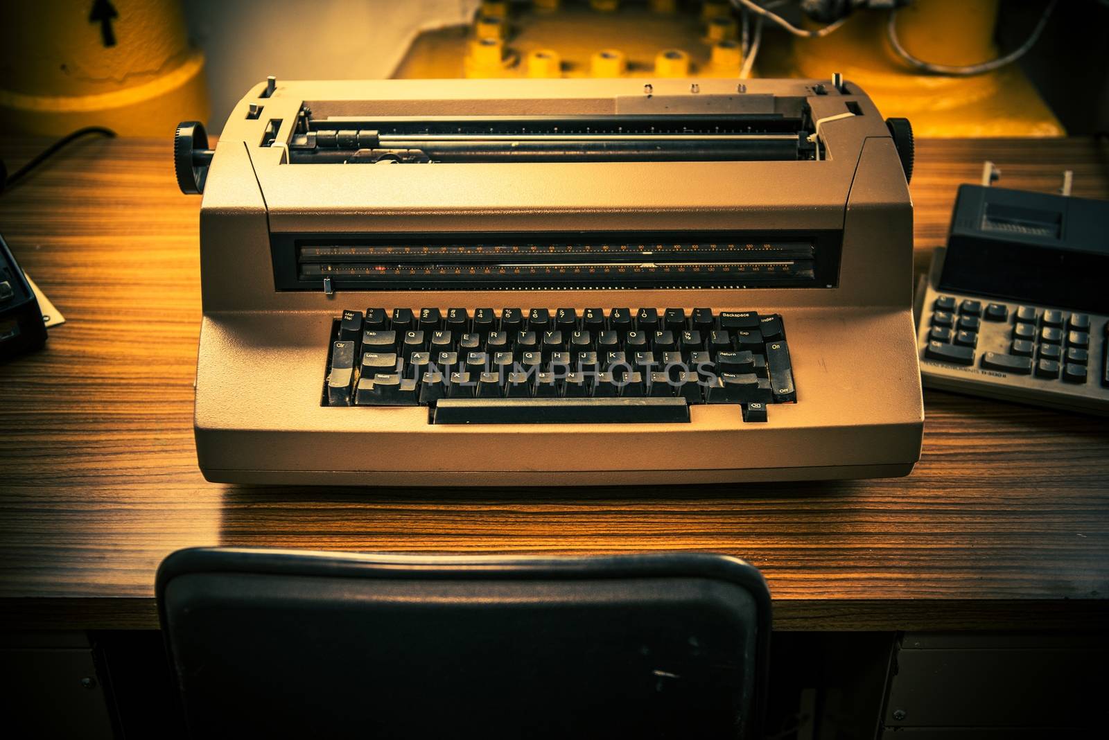 Vintage Electric Typewriter on the Aged Wooden Desk.