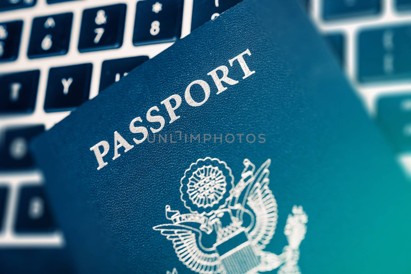 Online Travel Planning Concept Photo. United States of America Passport on the Computer Keyboard Closeup Photo.