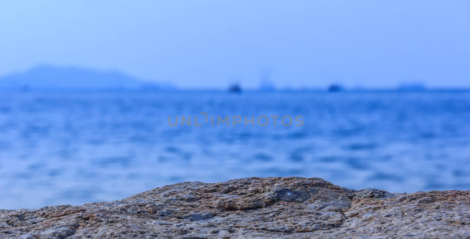 Rocks sea. Focus rocky sea blurred background. by suriyaph