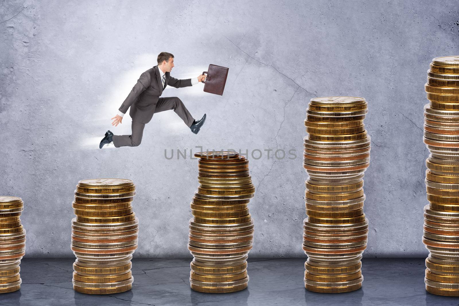 Businessman running on stack of coins on grey background