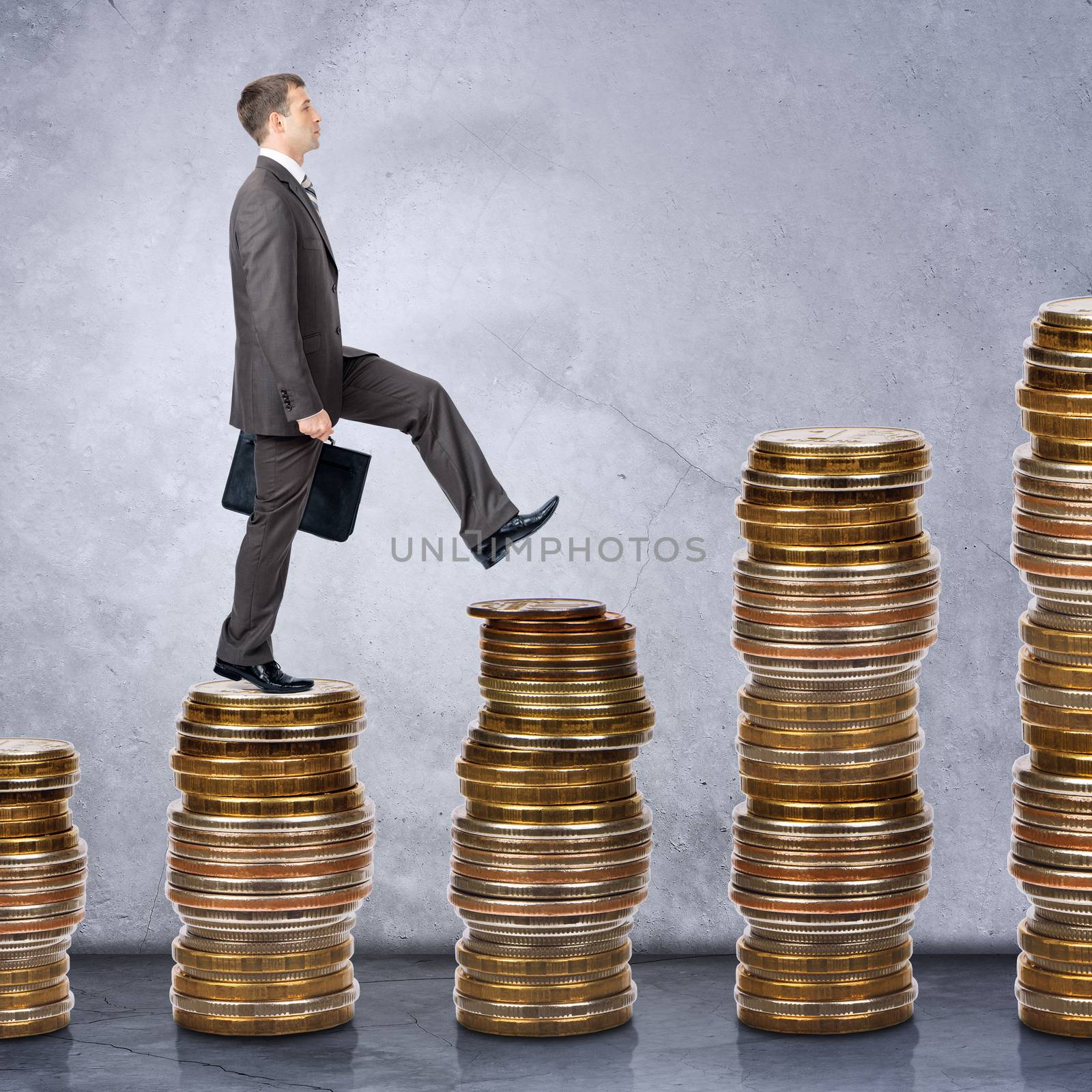 Businessman walking on stack of coins by cherezoff