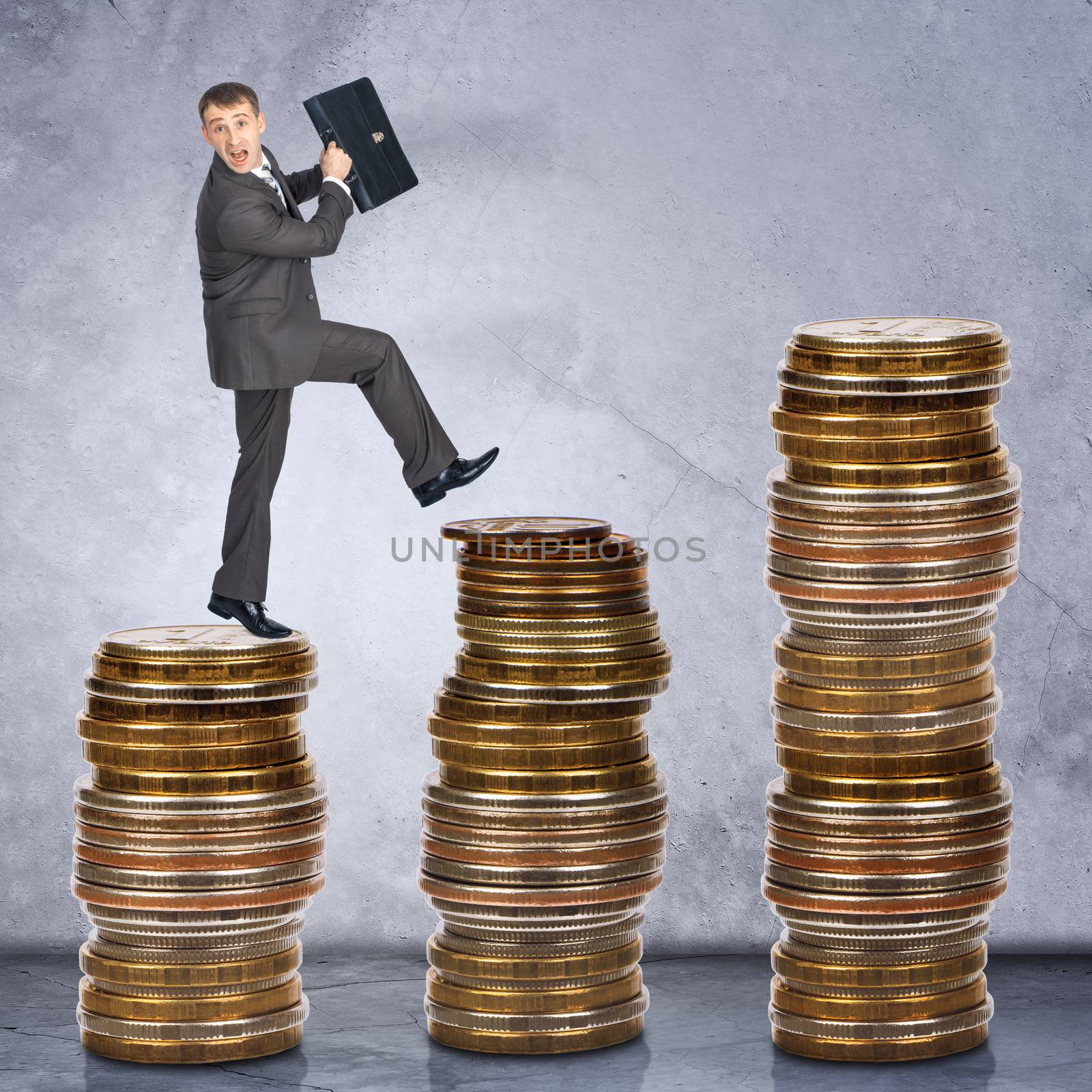 Scared businessman walking on stack of coins on grey background
