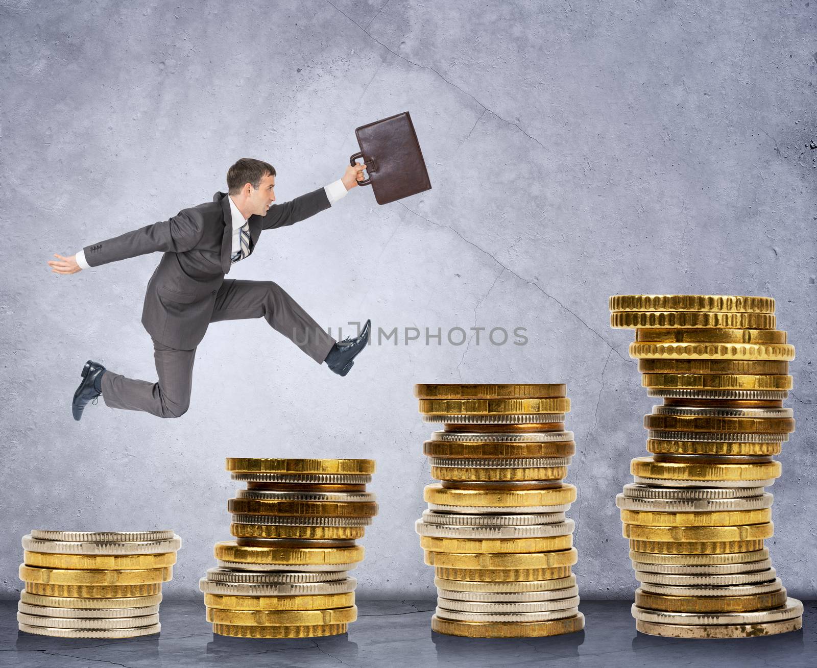 Businessman running on stack of coins on grey background