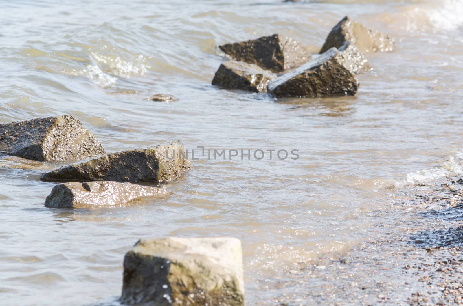 Waterside scenery with large stones on a river.