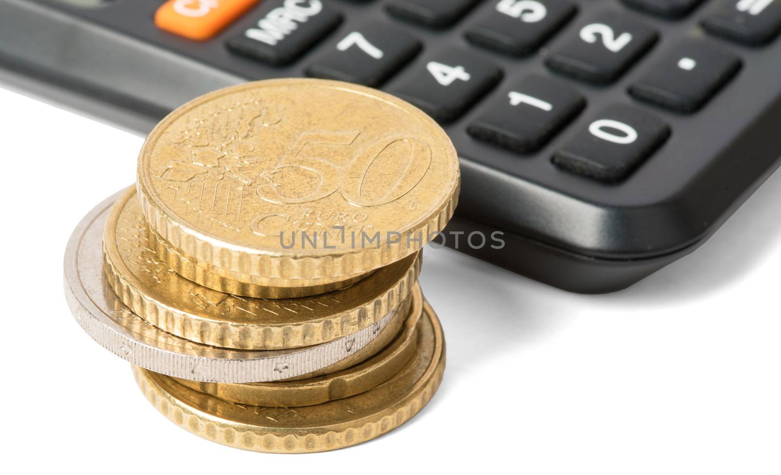 Calculator with stack of coins isolated on white background, closeup