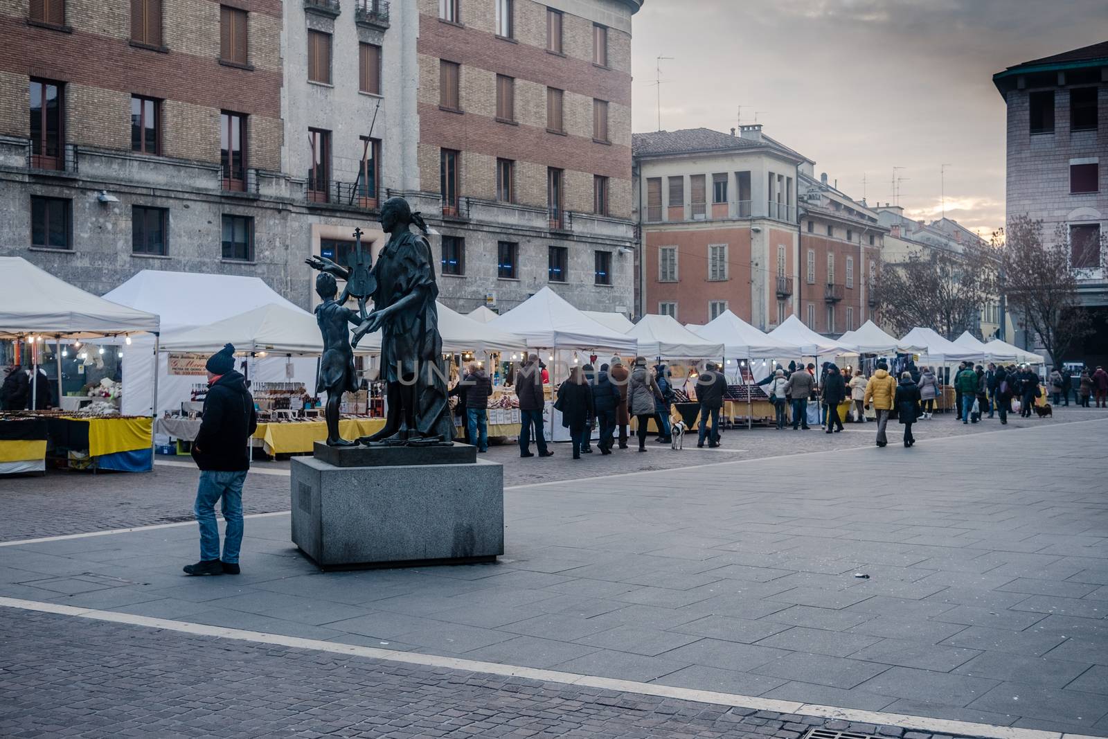 Street Market in italian city square during winter by verbano