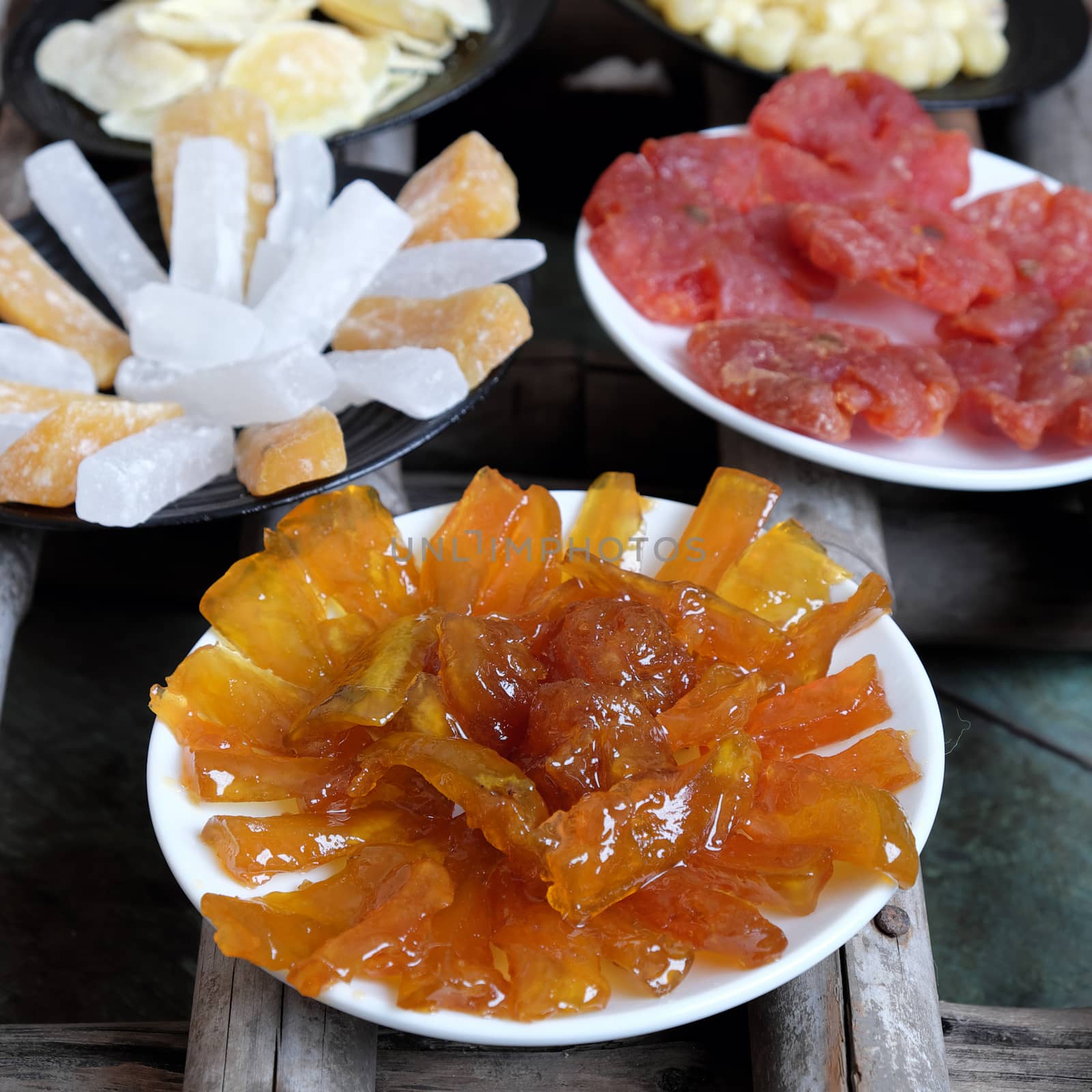 Amazing of Vietnamese food for Tet holiday in spring, jam is traditional food on lunar new year, make from sweet potato, lotus seed, ginger, mango with sugar, colorful background for Vietnam culture