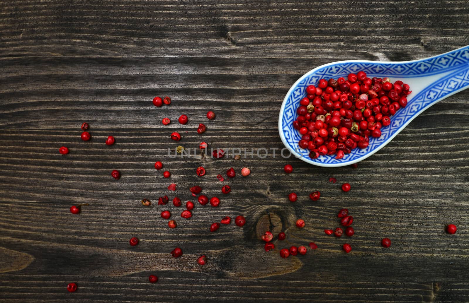 red pepper beans spoon over dark wood background