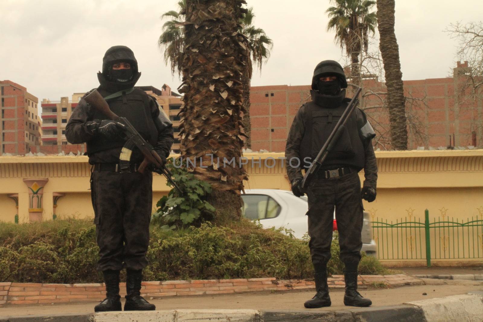 EGYPT, Cairo: Two members of the Central Security Forces, stand watch in Cairo, on January 25, 2016, on the 5 year anniversary of the 2011 uprisings. Tahrir Square saw a large security presence, after armed clashes broke out the previous two years between police and demonstrators.