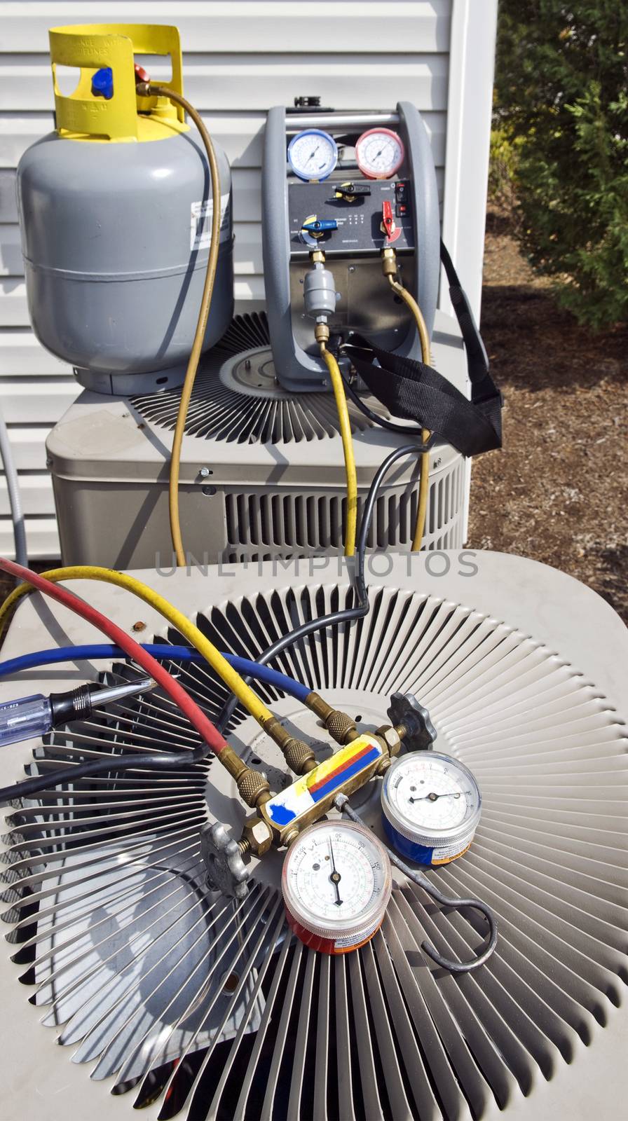 Vertical shot of air conditioning units with gauges for checking levels of freon.