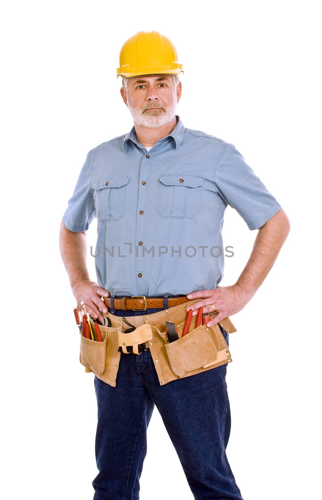 Vertical shot  portrait of a manual worker with tool belt.  Studio shot on white background.