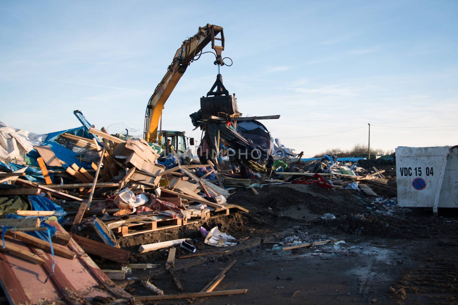 FRANCE, Calais: A bulldozer demolishes part of the Jungle in Calais, northern France on January 25, 2016.