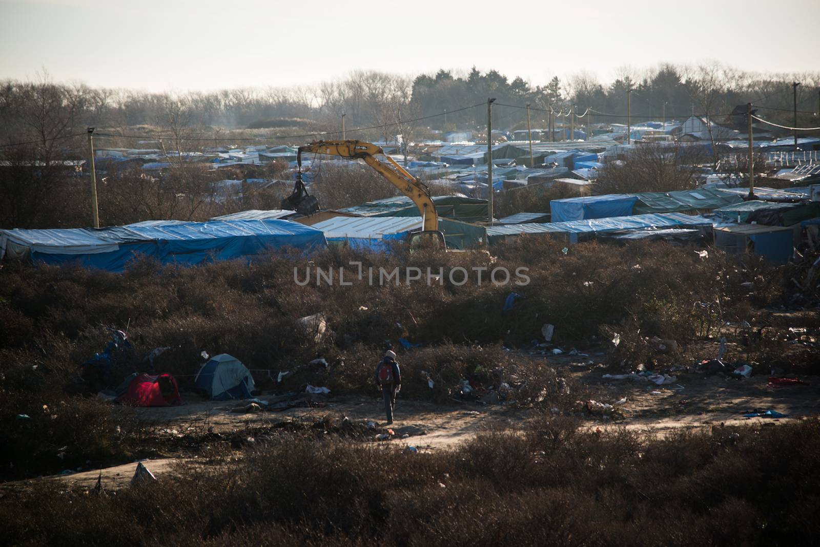 FRANCE, Calais: A bulldozer demolishes part of the Jungle in Calais, northern France on January 25, 2016.