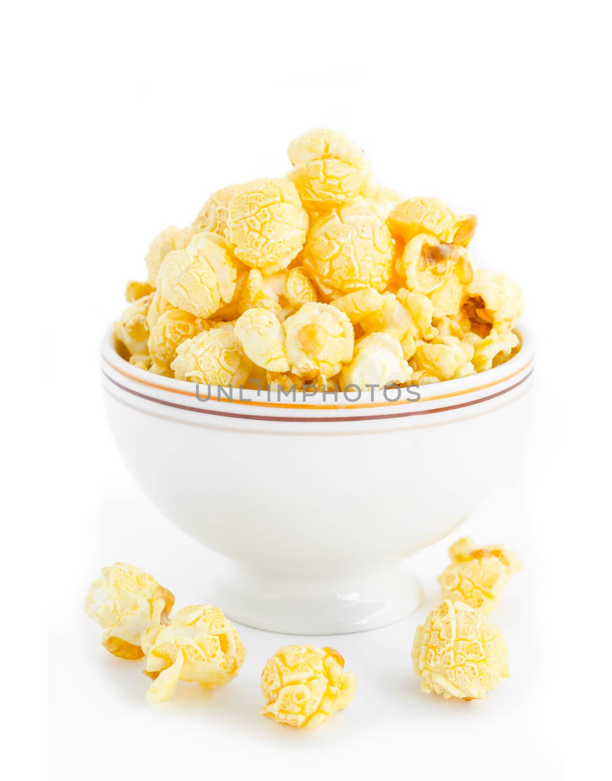 Popcorn in white bowl on white background.