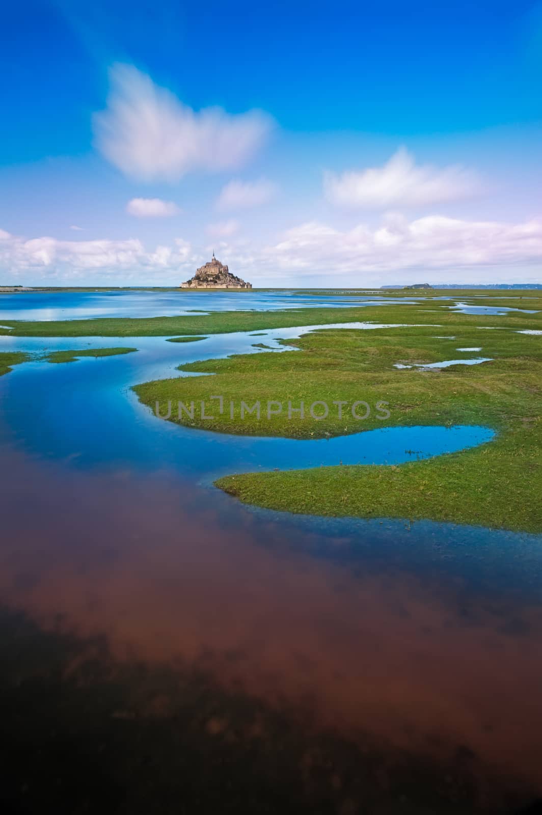 Mont Saint-Michel with clouds at a sunny day, Normandy, France by fisfra