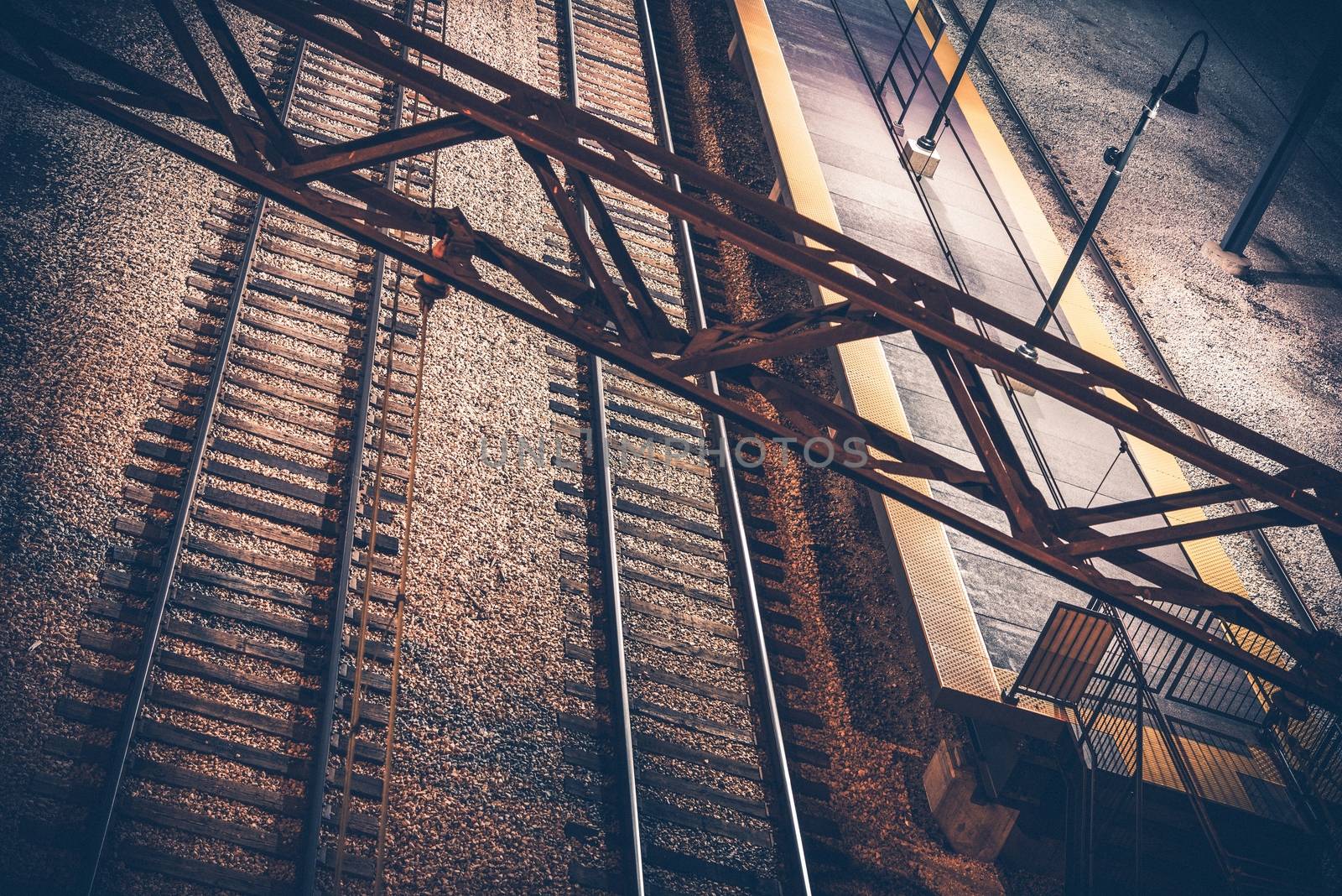 Train Station at Night. Two Railroad Tracks and Electric Systems.