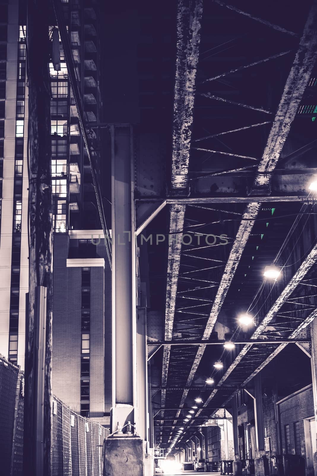 Urban Night. Chicago Alley with Train Bridge. Violet Color Grading. Chicago, United States.