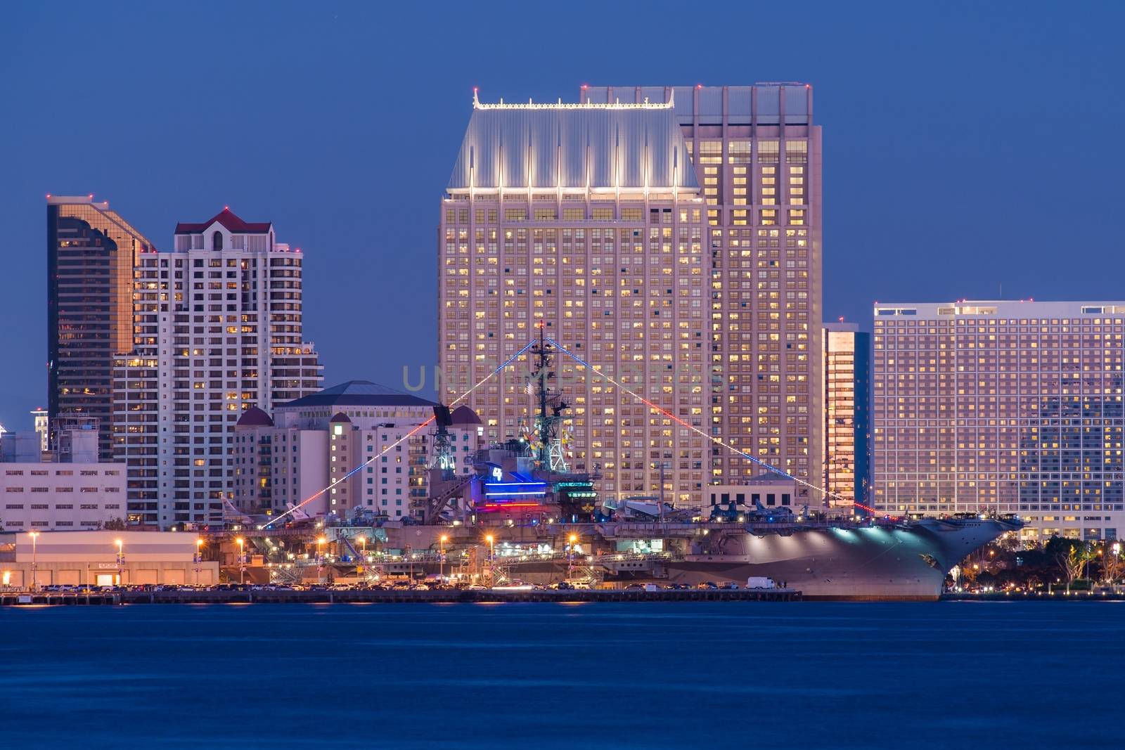 USS Midway and San Diego. USS Midway Aircraft Carrier Museum and San Diego Skyline at Night. California USA.