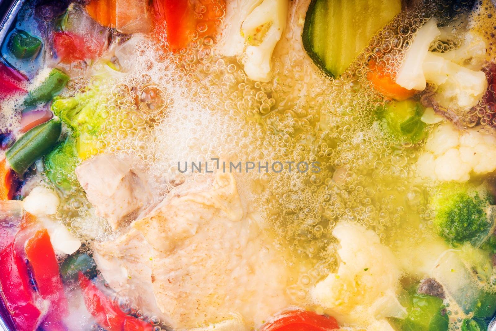 Colorful Full of Vegetables Chicken Noodle Soup Cooking. Boiling Noodle Soup Closeup.