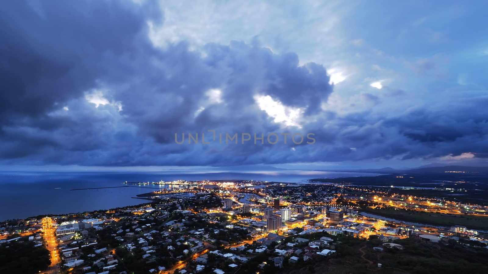 Dark monsoonal clouds hang over the North Queensland port city of Townsville. Queensland, Australia.