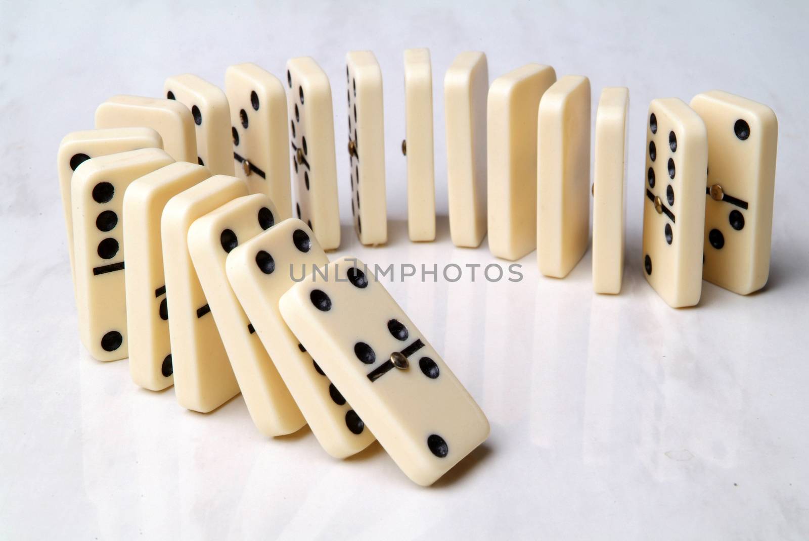 group of domino tiles in a semicircle shape on a neutral background