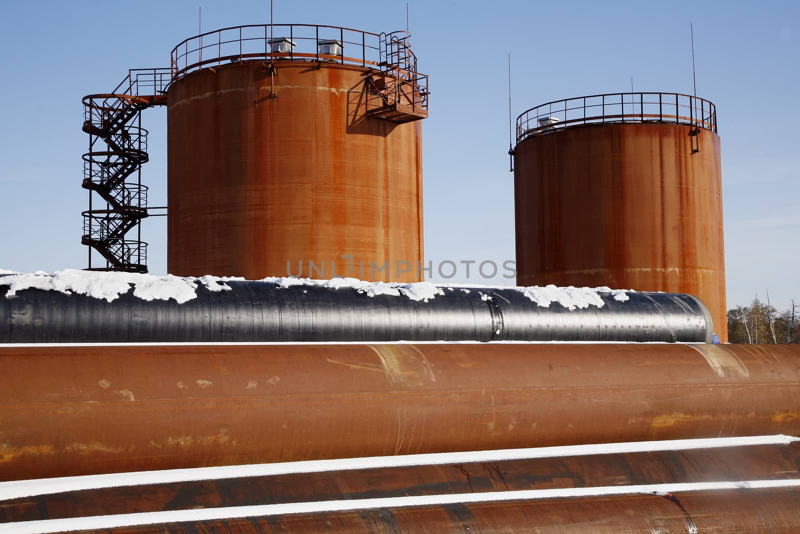 Tank storage crude Oil in winter landscape