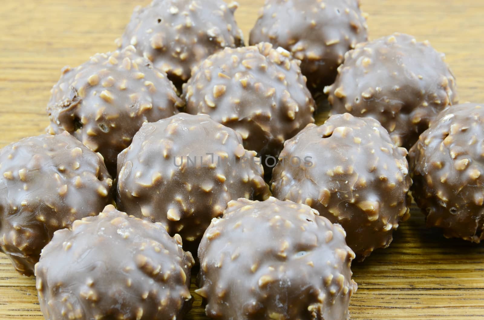 A variety of milk and dark chocolate truffles. on wooden background


