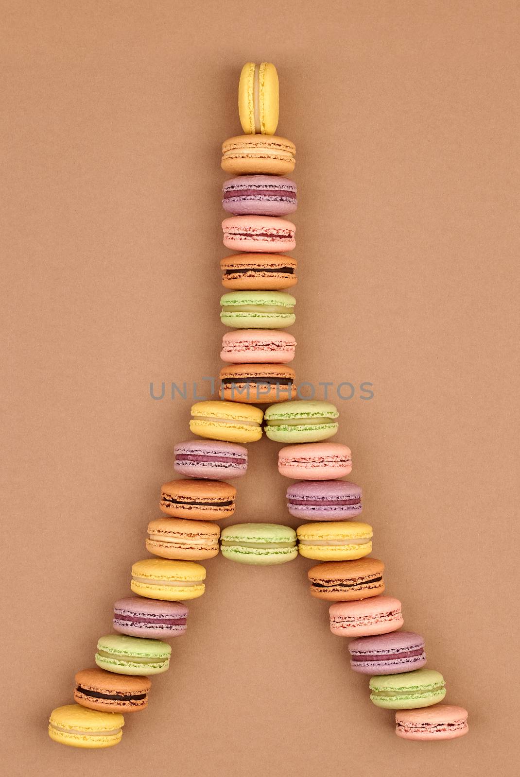 Macarons Eiffel Tower french sweet colorful. A lot of fresh  pastel delicious biscuit dessert on chocolate retro vintage background.                                           