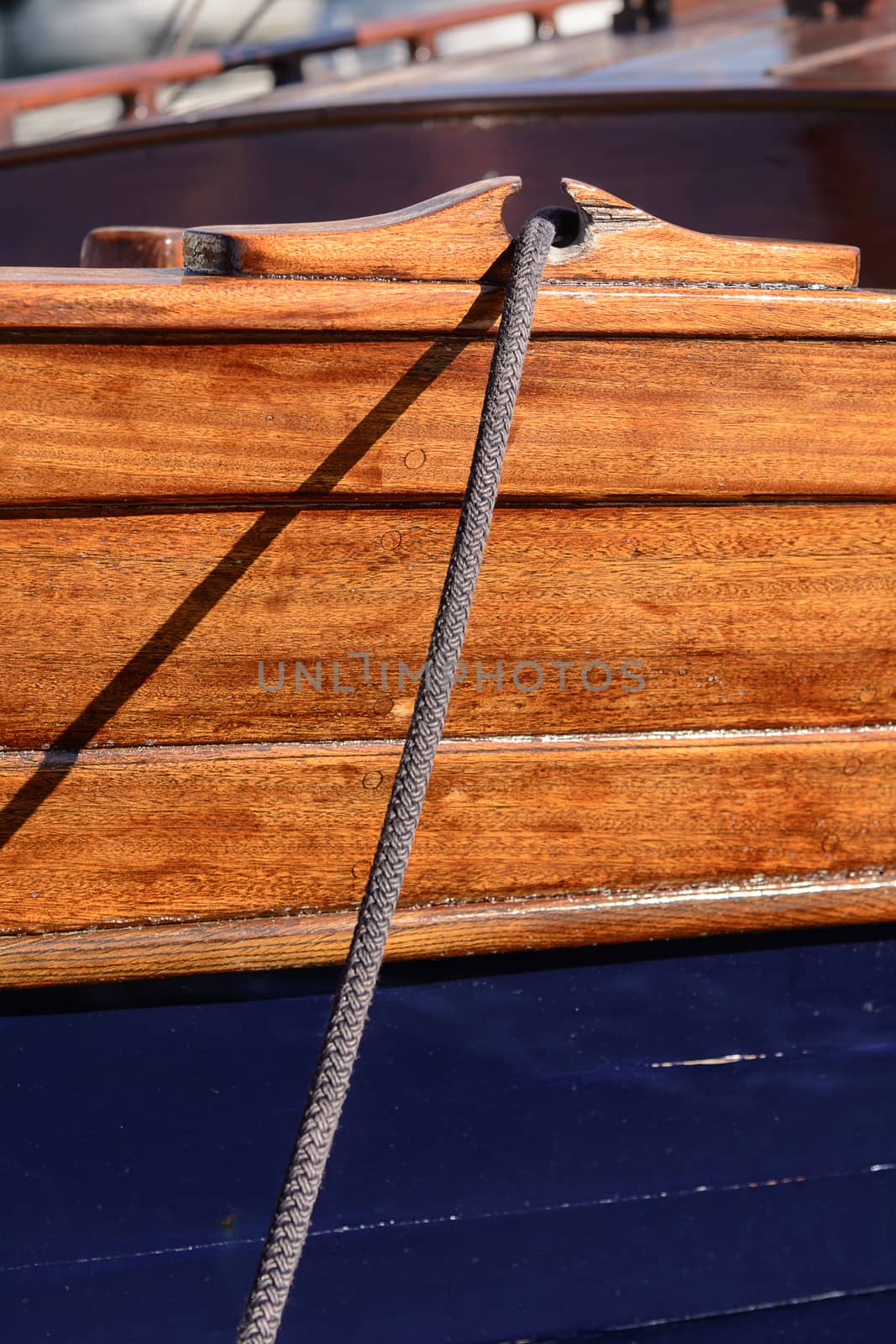 Fragmentary view details of knots and ropes on the yacht moored in the dock. Passing through the anchor.