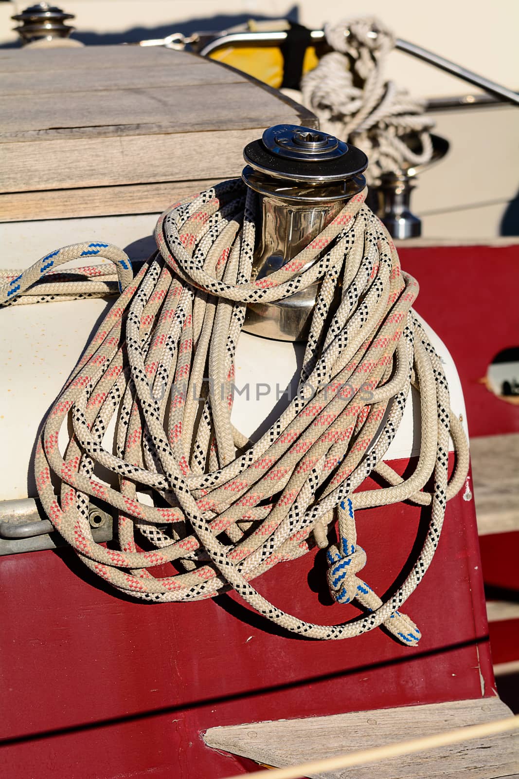 Fragmentary view details of knots and ropes on the yacht moored in the dock. 
Oarlock and rope on a sailboat.