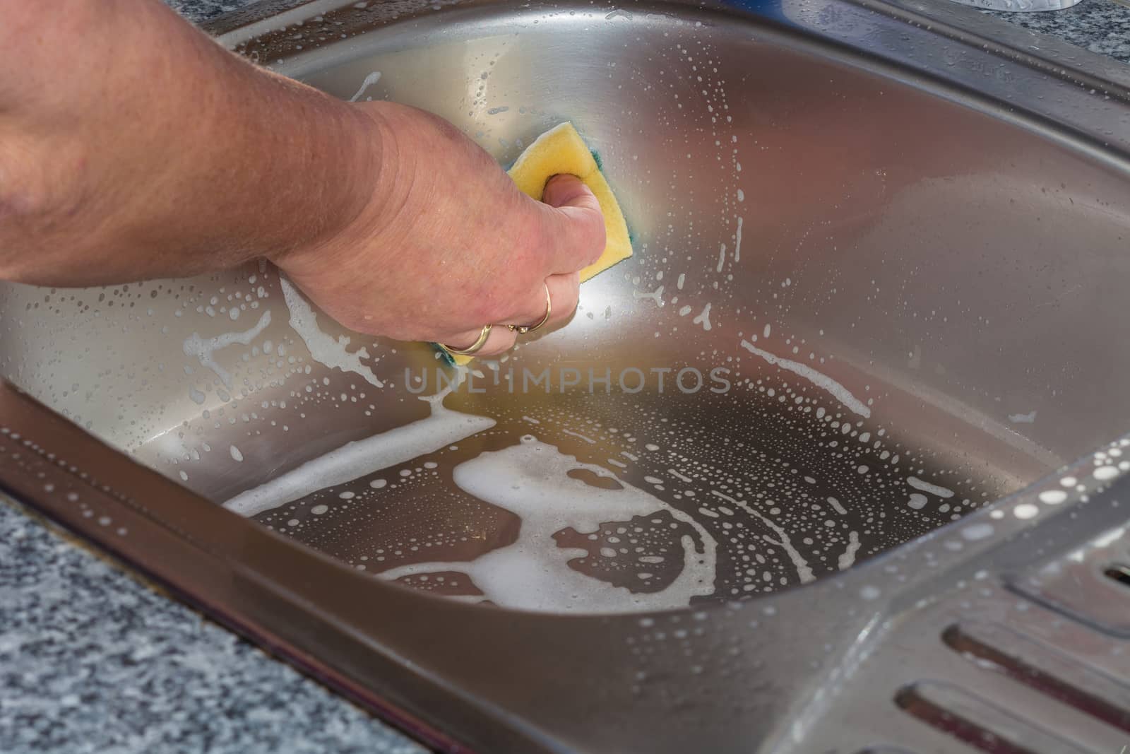 Cleaning a kitchen sink   by JFsPic