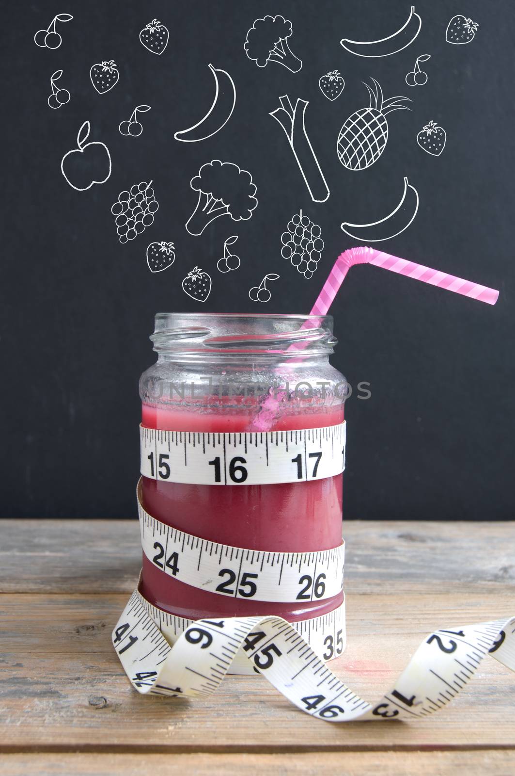 Healthy lifestyle fruits and vegetables sketched on a chalkboard appearing to fall into a smoothie jar with measuring tape