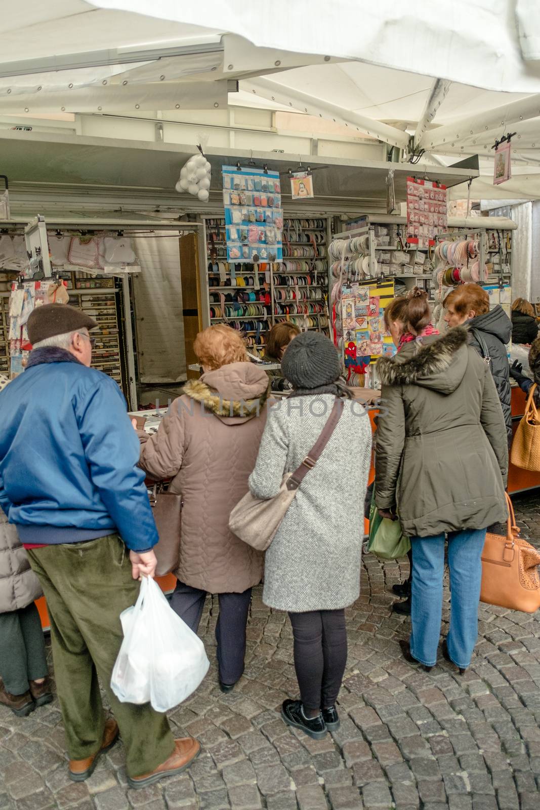 People shopping in the street market of Cremona, Italy. January 2016