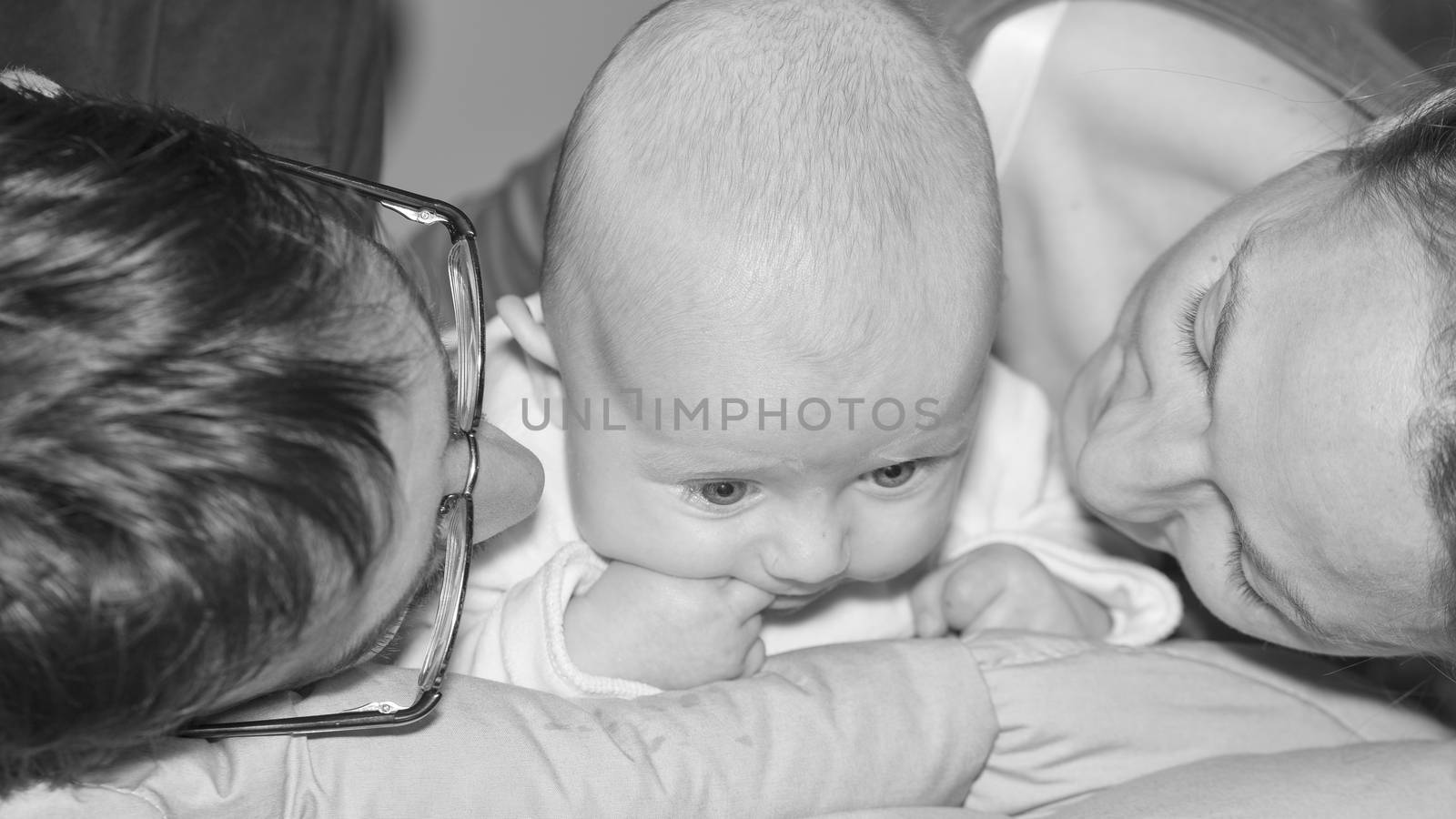 Happy and smiling portrait of Young Parents With Their Baby boy 4 month old Concept happy family
