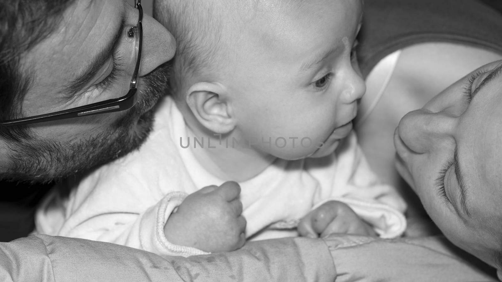 Happy and smiling portrait of Young Parents With Their Baby boy 4 month old Concept happy family