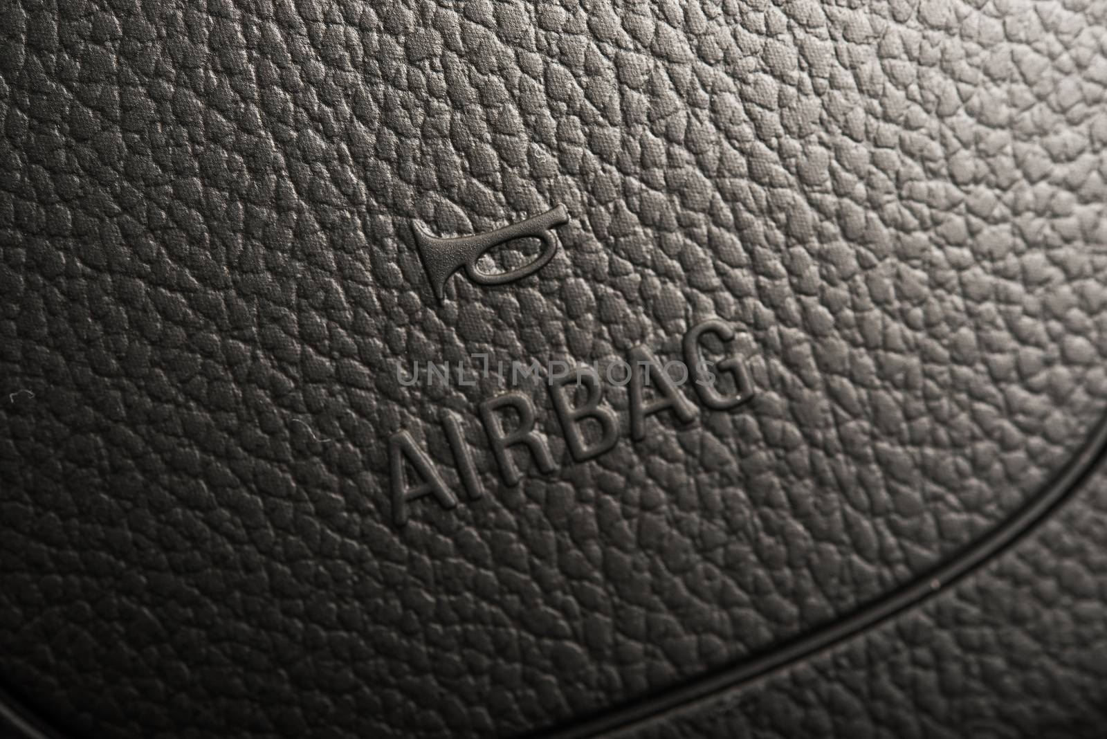 Steering Wheel Airbag Symbol Closeup Photo. Car Safety Feature.