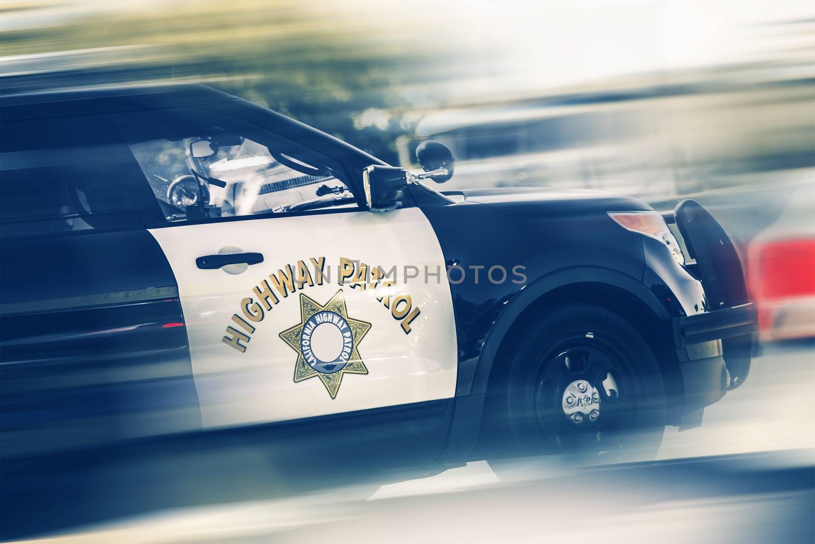 California Highway Police in Motion. SUV Police Cruiser on a Highway.