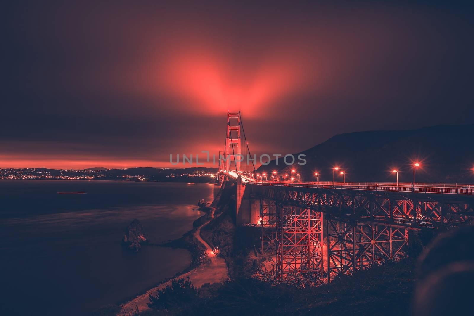San Francisco Bay and th Golden Gate Bridge in the Fog. Night Panorama with Reddish Color Grading.