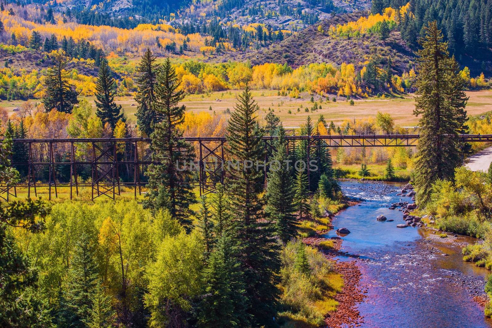 Colorado Fall Foliage. Yellow Aspen Trees, River and Old Railroad Tracks Bridge. Colorado, United States.