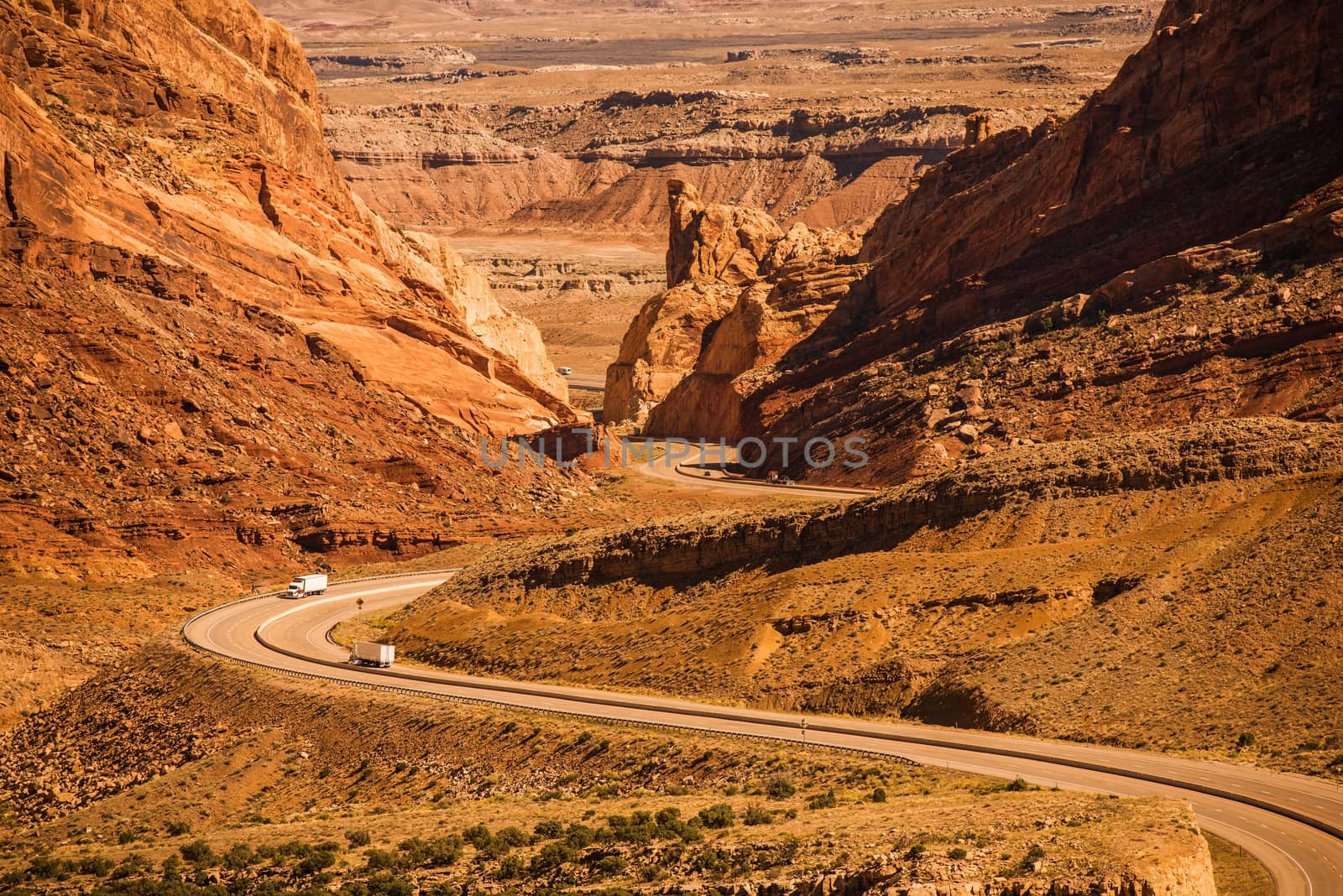 Rocky Desert Utah Highway with Semi Trucks. Scenic Utah Interstate Highway I-70. United States.