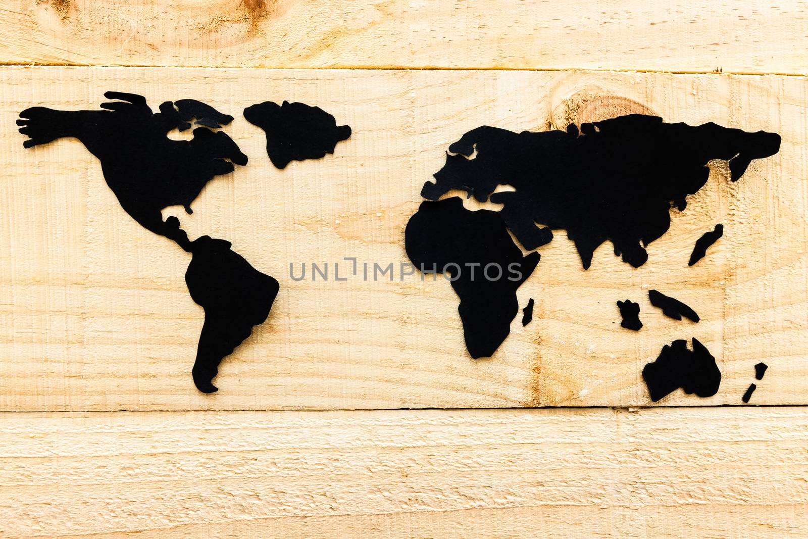 Photo illustration showing the world in wood background and paper