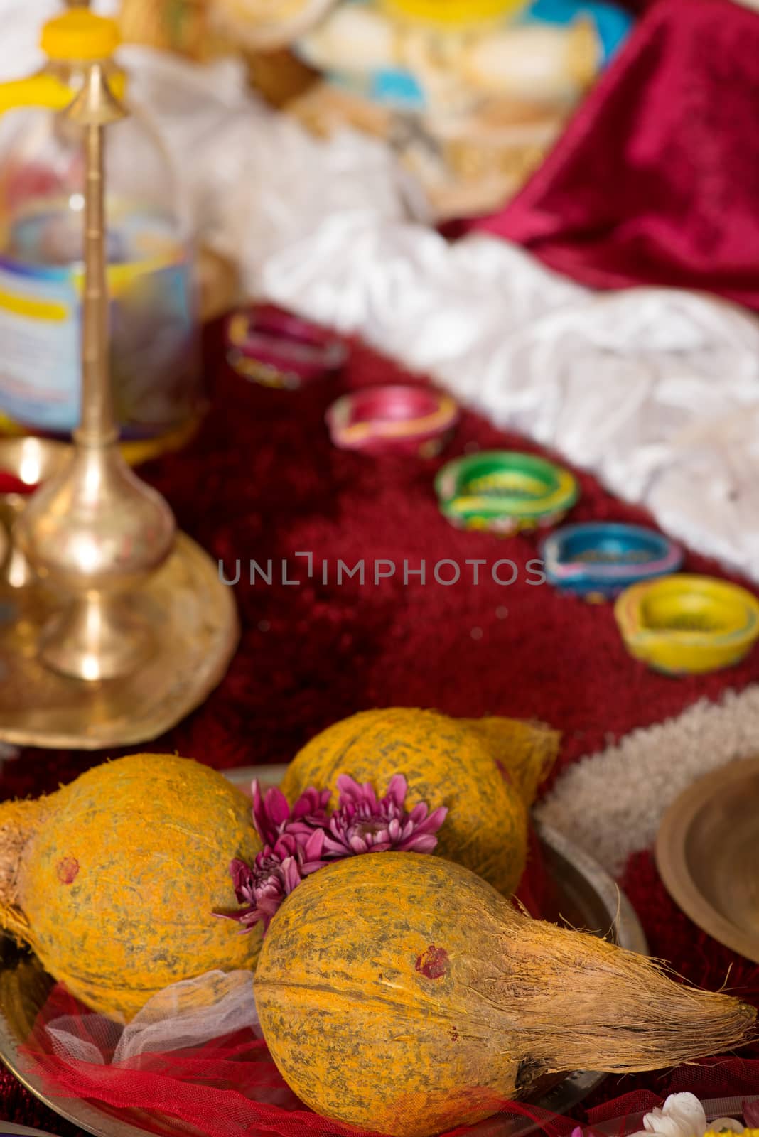 Traditional Indian Hindu religious praying items in ear piercing ceremony for children. Focus on the coconuts.