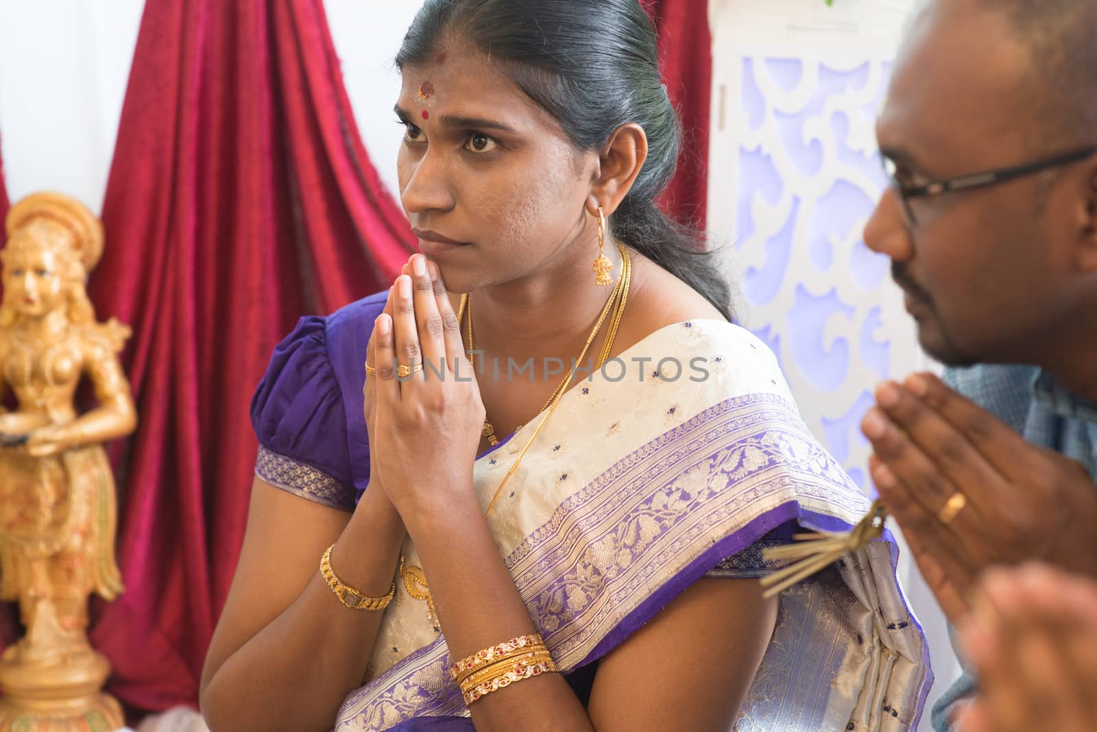 People pray during praying events. Traditional Indian Hindus ear piercing ceremony. India special rituals.