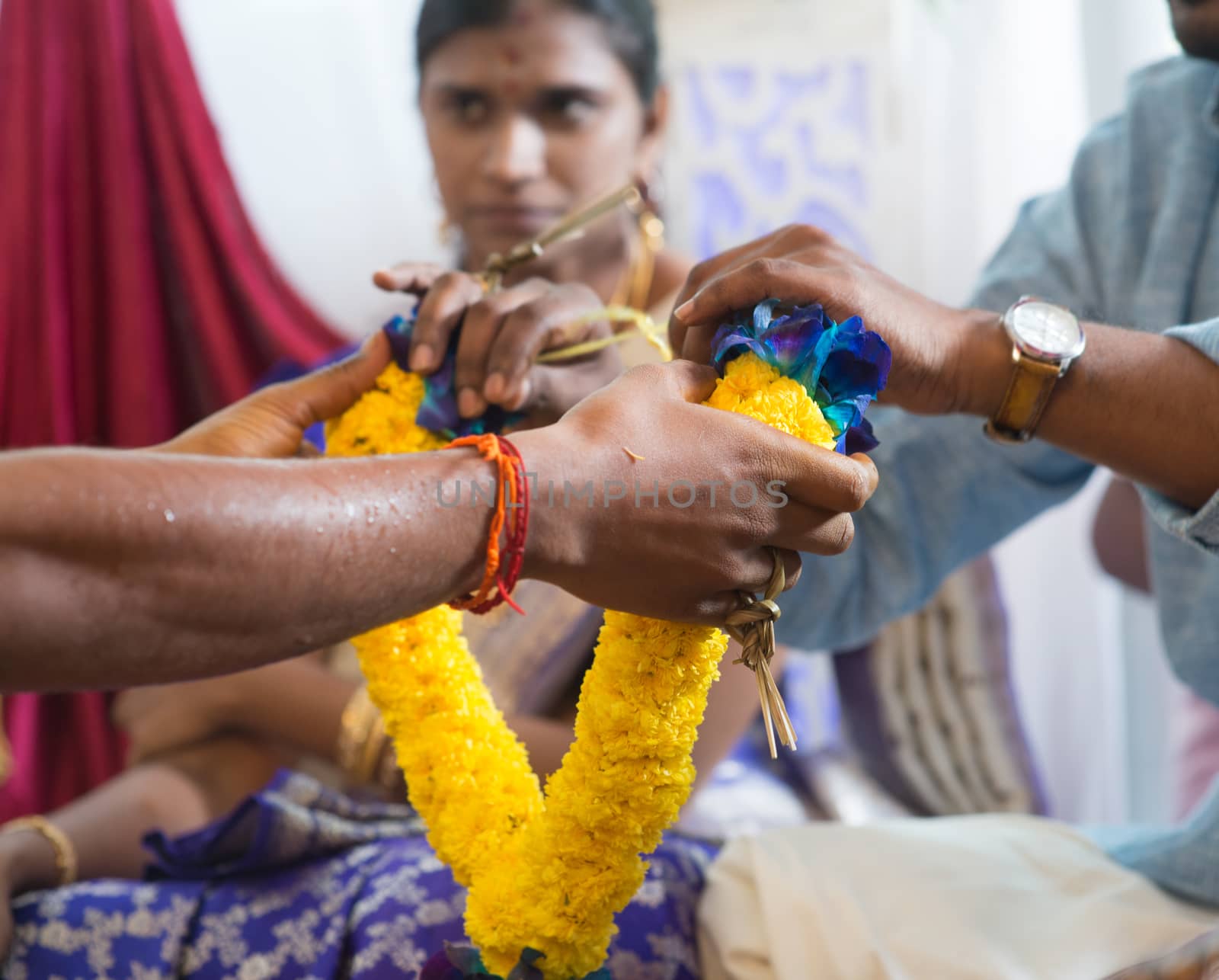 People received flower garland from priest. Traditional Indian Hindus ear piercing ceremony. India special rituals.