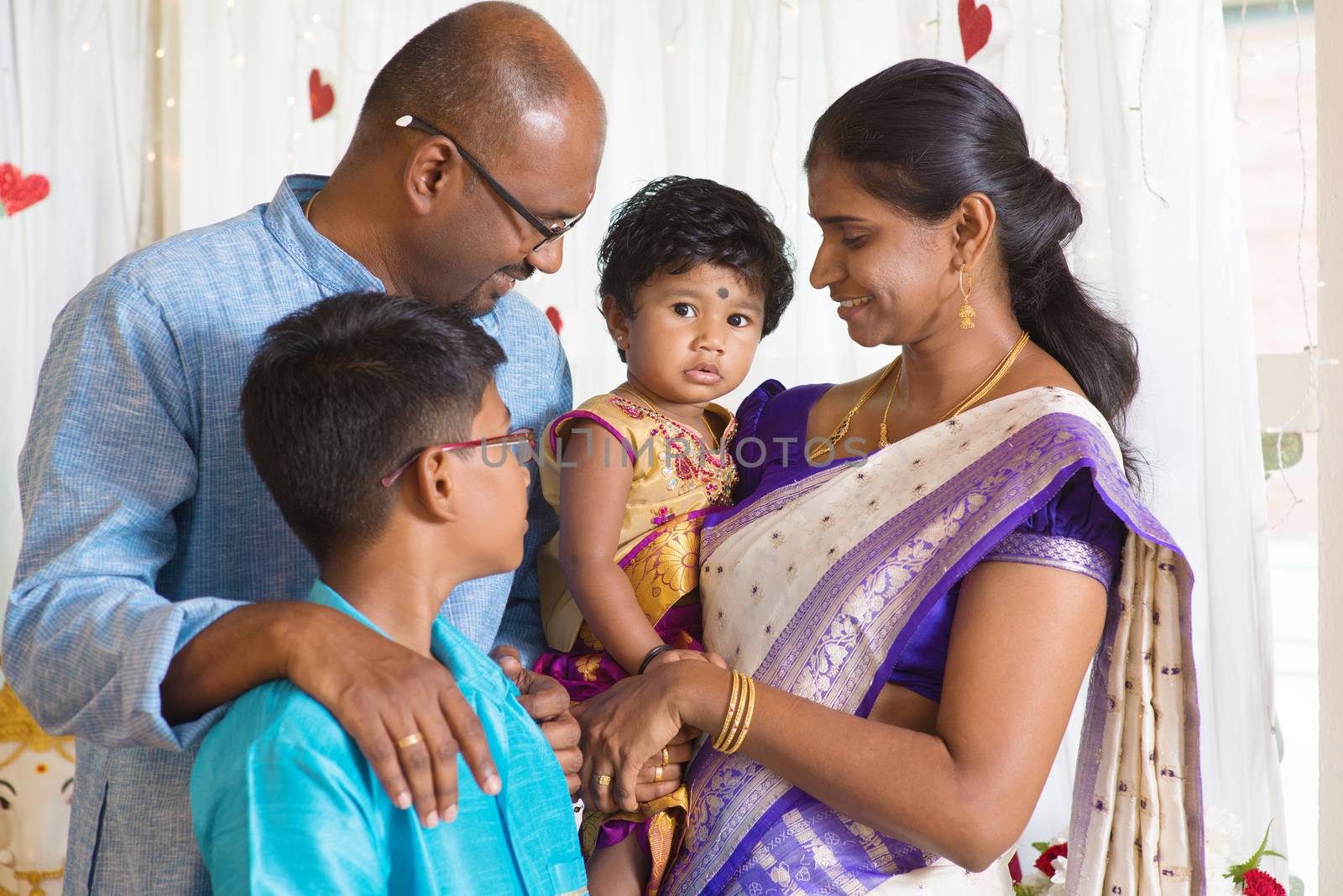 Traditional India family portrait. Indian parents and children in a blessing ceremony. 