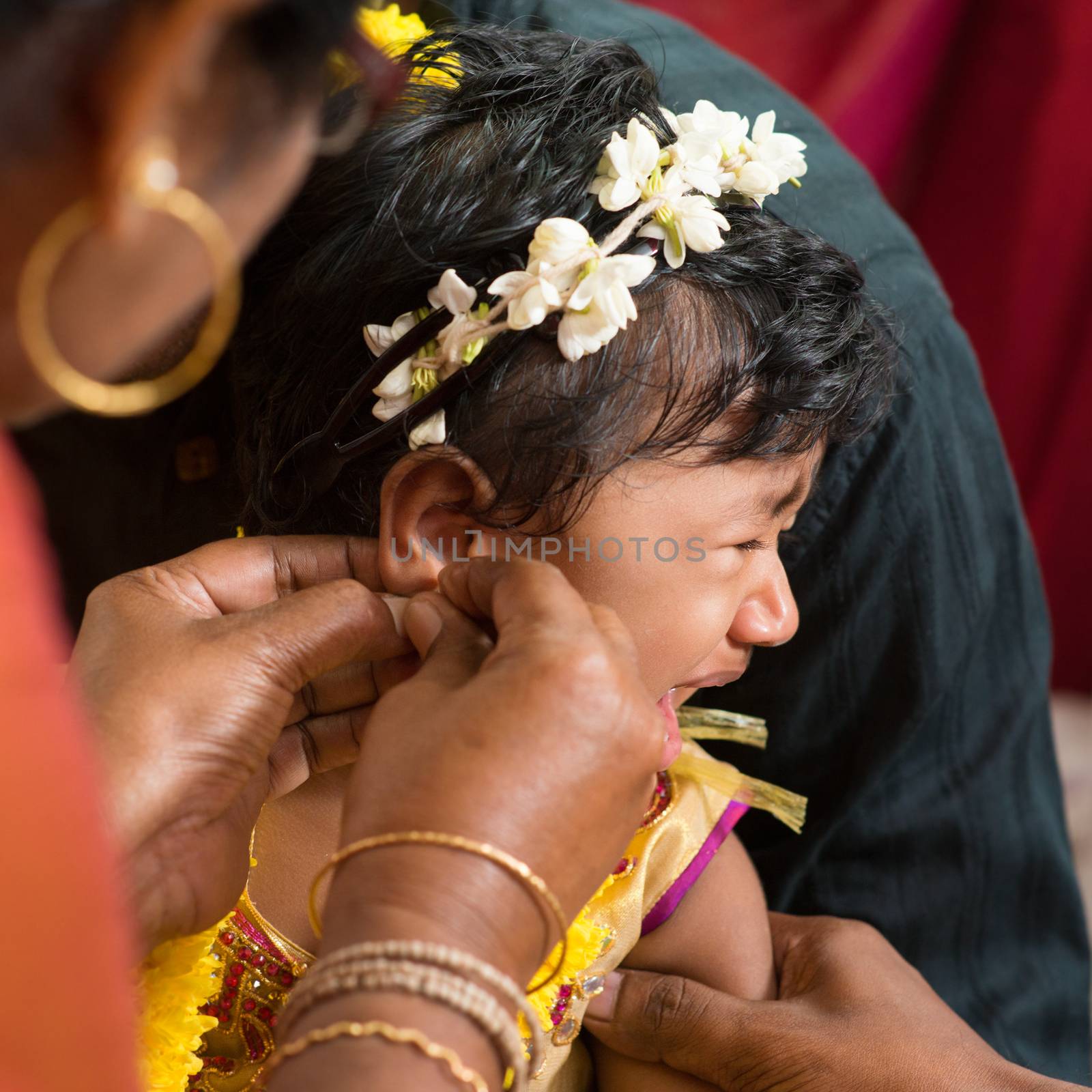 Traditional Hindu having ear piercing ceremony by szefei